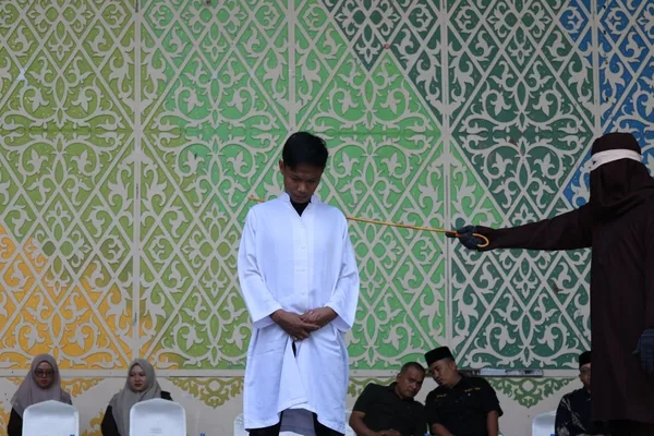 Indonesian couple receives 21 lashes for public kiss under Islamic law
