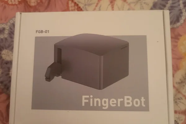 Tiny robot physically presses buttons for home automation
